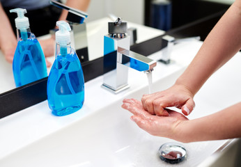 Detail of washing hands in the bathroom