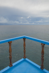 Boats parked n a green coast of tropical Apo Island, Philippines.