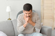 © Pixel-Shot - Coughing young man at home