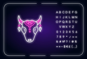 Tribal cattle head neon light icon. Cow skull with feathers. Wild animal head, mystic amulet. Outer glowing effect. Sign with alphabet, numbers and symbols. Vector isolated RGB color illustration