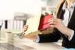 © Antonioguillem - Executive hands unboxing package with agenda at the office
