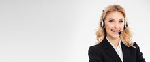 Portrait Of Happy Smiling Young Support Phone Operator Or Confident Businesswomen In Headset, Over Grey Background, With Blank Copy Space Area For Slogan Or Text Message.