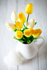 Wall Mural - bouquet of spring tulips on a bright background. greeting card. space for text.