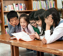 Group Of Children Reading Book Together,with Happy Feeling,at Library,Lens Flare Effect,blurry Light Around
