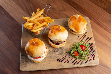 Wall Mural - close up of fresh tasty mini burgers and potatoes