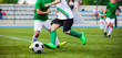 Running Football Soccer Players. Sports Competition Between Youth Soccer Teams. Young Boys in Hard Duel Playing Soccer Game. Junior Footballer Kicking Soccer Ball