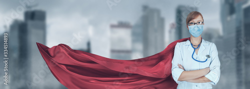 Fotografía Portrait of young medical doctor hero woman with super person red cape protect c