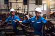 © Thirawatana - Professional technicians and two engineers are working in industrial plants. Professional technicians and engineers are working in fatory plants that work on steel. Working together.
