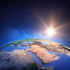 Wall Mural - sun shining over middle east from space