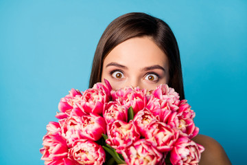 Sticker - Close up photo of positive crazy funky girl hide her face with many tulips flowers impressed by 8-march 14-february gift isolated over blue color background