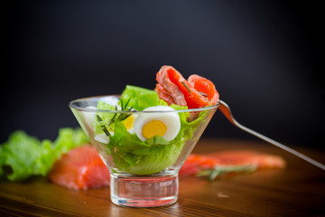 Wall Mural - lettuce salad with salted salmon, boiled eggs