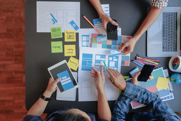 soft focus and blur,a group of web designers are working together to develop a mobile responsive web