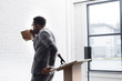 © LIGHTFIELD STUDIOS - nervous african american speaker breathing with paper bag and having panic attack during business conference in office