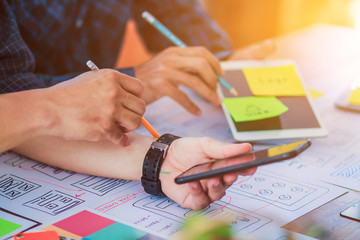 soft focus and blur,a group of web designers are working together to develop a mobile responsive web