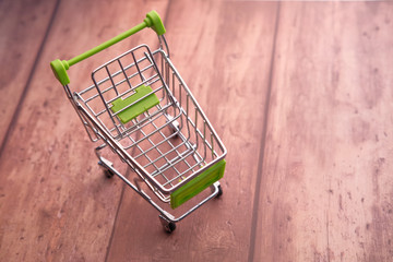 shopping cart on wooden table, online shopping.