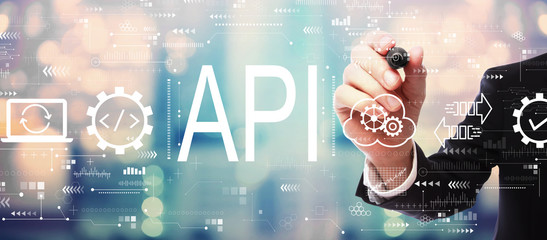 API - application programming interface concept with businessman on blurred abstract background
