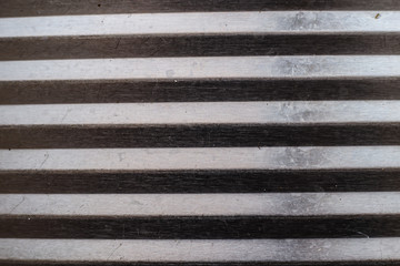 Wooden plank. On the board are white and black stripes.