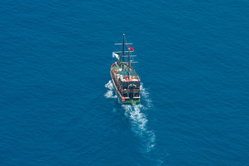 Wall Mural - Alanya. Turkey. Mediterranean Sea. Traditional entertainment resort of Alanya. Sailing aka pirate ships around the fortress of Alanya. View from the bird's-eye view.