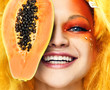 face of a young girl with papaya on a white background