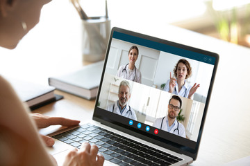 Wall Mural - close up of young female talk on video call consult with diverse doctors colleagues, woman patient h