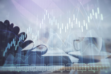 Double exposure of financial chart drawing and desktop with coffee and items on table background. Concept of forex market trading