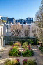 Paris, France - March 25, 2020: Haussmann Buildings And Private Garden In Cardinal Lemoine Street In Paris