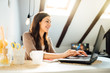 © eldarnurkovic - Business woman working from home on laptop computer.Checking email.Working from distance.Online business career.Writer editor.Quarantined office employee using laptop.Freelance worker.Home office