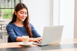© chayathon2000 - Asian woman using computer laptop and drink coffee work from home concept