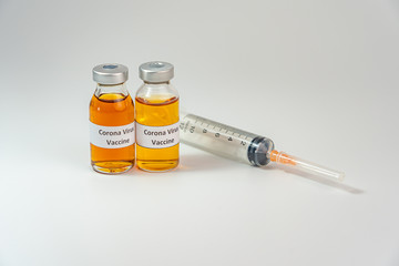 Bottles of Coronavirus vaccine on white background with syringe injection