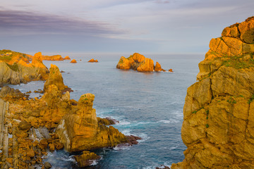 Wall Mural - Incredible cliffs on the coast near the village of Liencres before sunrise. Cantabria. Northern coast of Spain