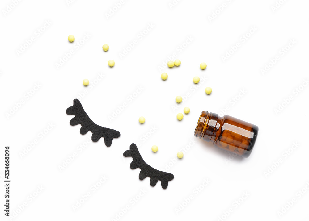 Composition with sleeping pills on white background