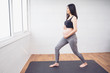 © Have a nice day  - Beautiful asian pregnant woman training yoga standing caressing baby belly standing pose practice breathing, healthy and fit motherhood feeling happy and strong, pregnancy expecting   new born baby