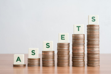 Word ASSETS on step stack coins as graph up. Asset management, Investment and saving money for wealth concept