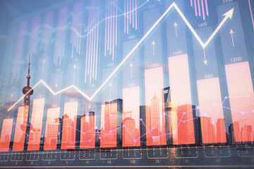 Forex graph on city view with skyscrapers background double exposure. Financial analysis concept.