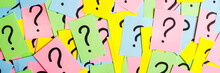 Too Many Questions. Pile Of Colorful Paper Notes With Question Marks. Closeup.