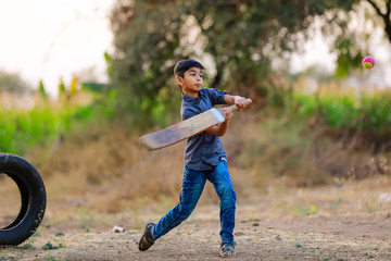 Wall Mural - Rural Indian Child Playing Cricket