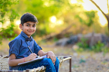 Wall Mural - Cute indian child studying at home