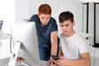 © rozaivn58 - Two serious teenager guys are using  computer and discussing something