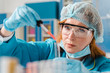 © FreepikCompany - Young ginger woman chemist looking at a sample