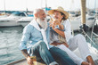 © Alessandro Biascioli - Senior couple toasting champagne on sailboat vacation - Happy elderly people having fun celebrating wedding anniversary on boat trip - Love relationship and travel lifestyle concept