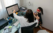 © David Pereiras - Top view of woman teleworking with daughter dancing with her