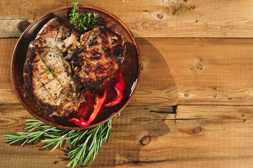 steak in a plate on a wooden background