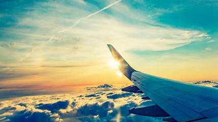 Wall Mural - flying and traveling.sunset viewed from airplane 