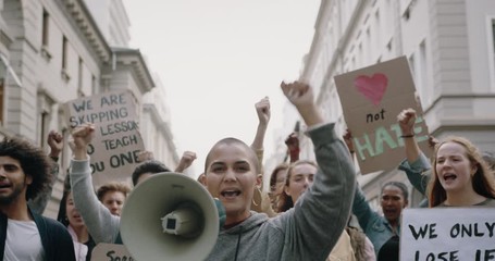 Wall Mural - Group of demonstrators protesting during a march in the city. Social activists going on strike and demonstrating with slogans on the street.
