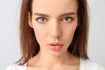 Sticker - Young woman with beautiful makeup on light background