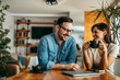 © bnenin - Portrait of two people having coffee break at work.