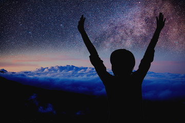 Wall Mural - woman enjoying starry night with arms wide open.