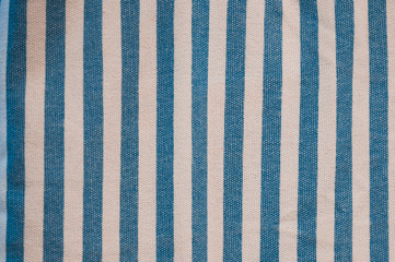 A beautiful and simple blue and white striped fabric made out of wool and cotton with a repeated pattern.