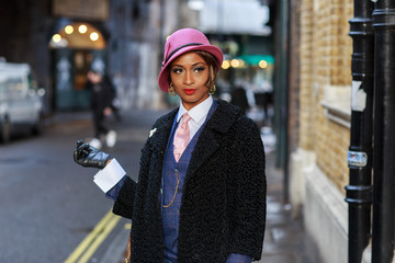 Wall Mural - young portrait of a woman dressed in a tweed suit, hat and gloves