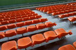 © travelers.high - Orange spectator seats in a sports stadium